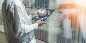Doctor holding tablet with health-related icons, showcasing modern medical technology