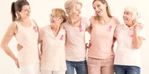 Breast cancer awareness group of women wearing pink ribbon.