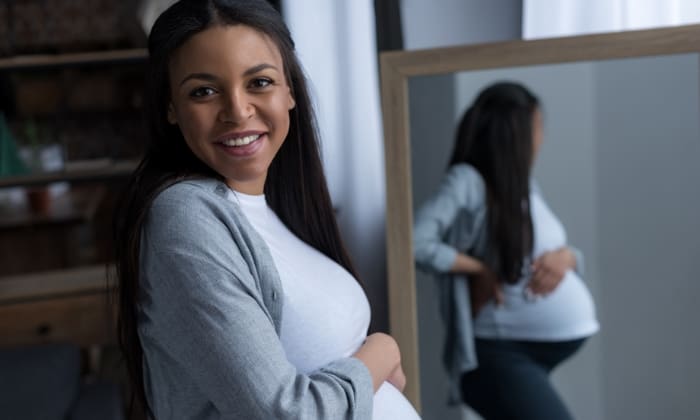 Cheerful African American Pregnant Woman Standing