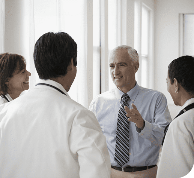 Senior businessman discussing with a team of health