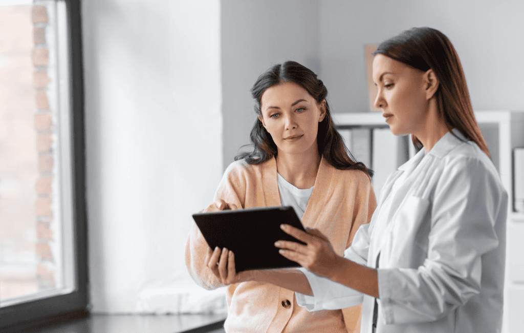 Patient looking at a digital tablet with healthcare provider